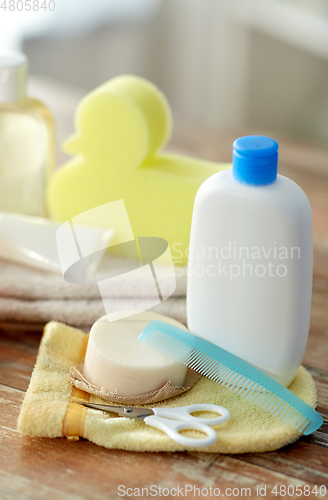 Image of baby accessories for bathing on wooden table