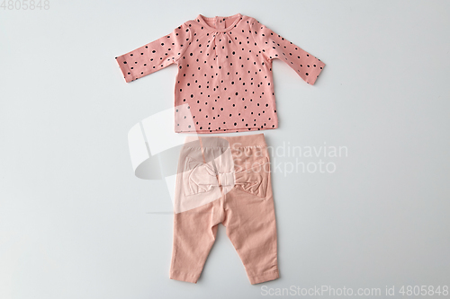 Image of pink shirt and pants for baby girl over white