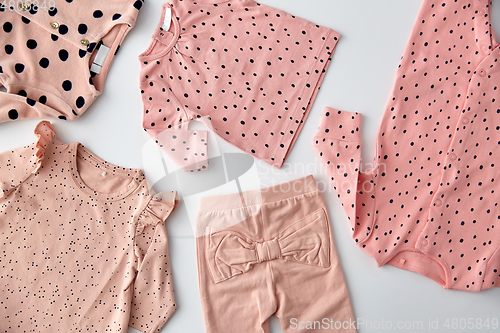 Image of pink clothes for baby girl on white background