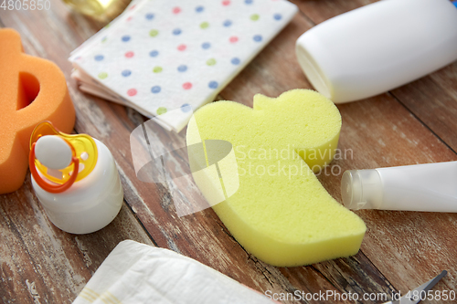 Image of baby accessories for bathing on wooden table