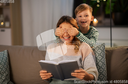 Image of happy smiling mother playing with her son at home