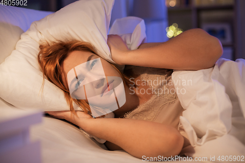 Image of annoyed woman suffering from insomnia at night