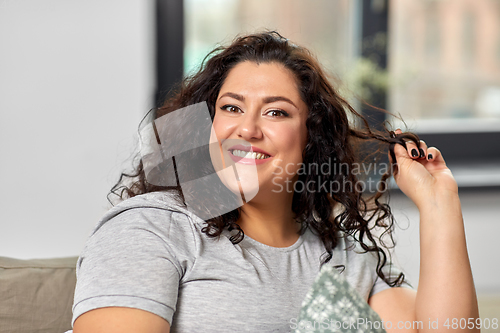 Image of portrait of happy young woman at home