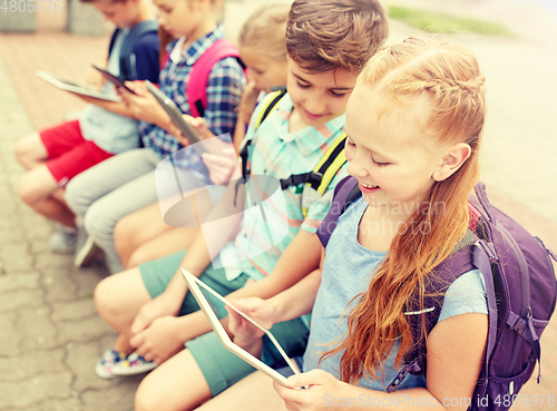 Image of group of happy elementary school students talking