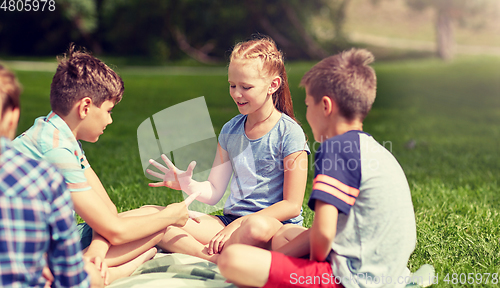 Image of happy kids playing rock-paper-scissors game