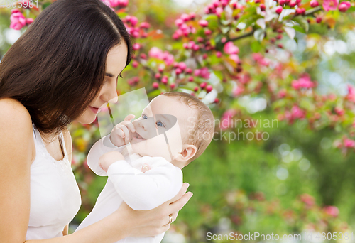 Image of mother with baby over spring garden background