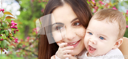 Image of mother with baby over spring garden background