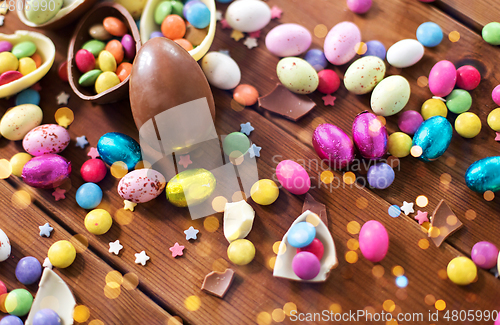 Image of chocolate eggs and candy drops on wooden table