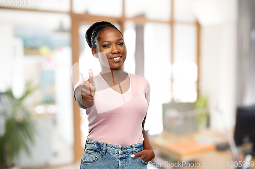 Image of african woman showing thumbs up at office