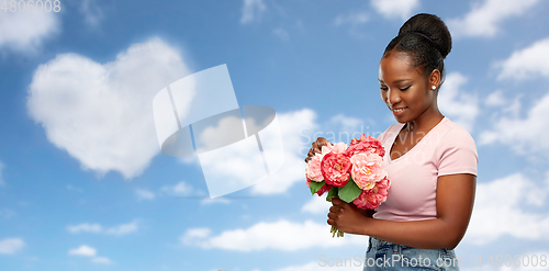 Image of happy african american woman with bunch of flowers