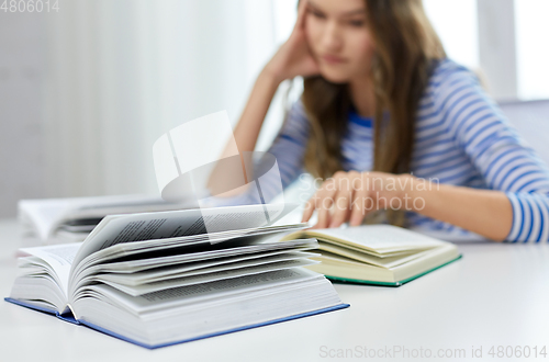 Image of close up of student girl reading books at home