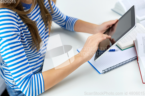 Image of student girl using tablet pc computer at home