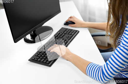 Image of close up of teenage girl with computer at home