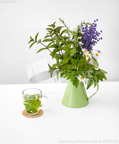 Image of herbal tea and flowers in jug