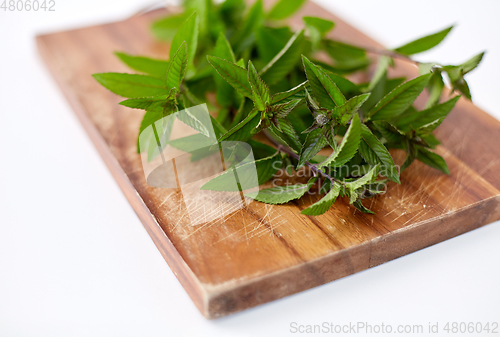 Image of bunch of fresh peppermint on wooden cutting board