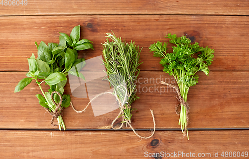 Image of greens, spices or medicinal herbs on wooden boards