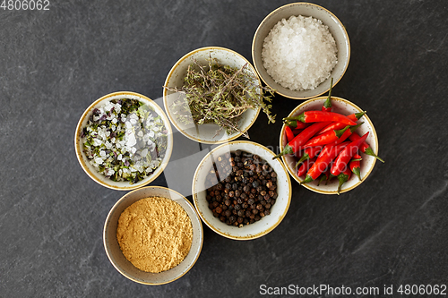 Image of bowls with different spices on slate stone table