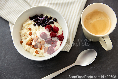 Image of porridge breakfast with berries, almonds and spoon