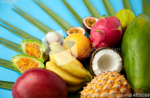 Image of different exotic fruits on blue background