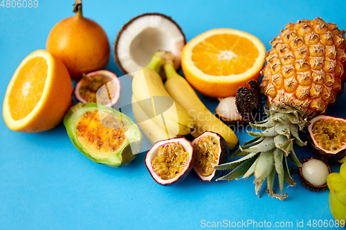 Image of different exotic fruits on blue background