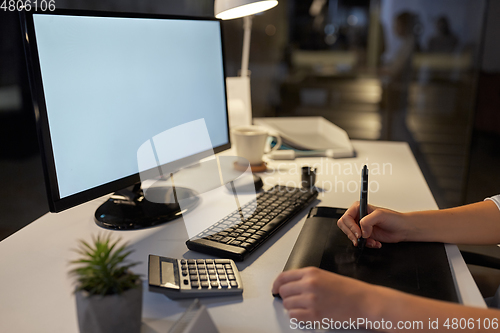 Image of designer with computer and pen tablet at office