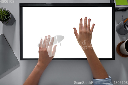 Image of hands on led light tablet at night office