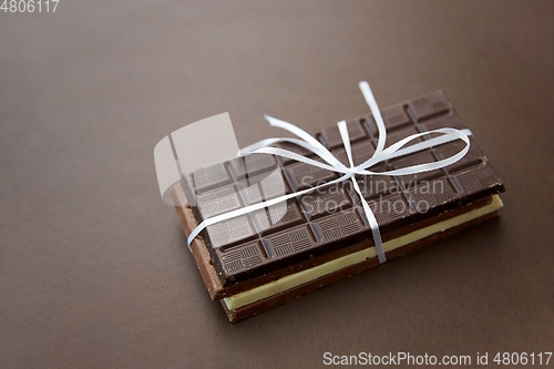 Image of different kinds of chocolate on brown background