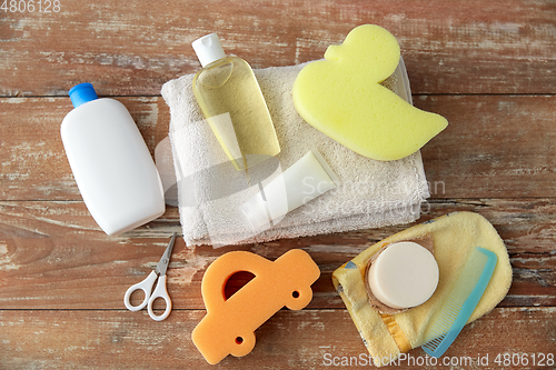 Image of baby accessories for bathing on wooden table