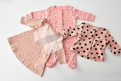 Image of pink clothes for baby girl on white background
