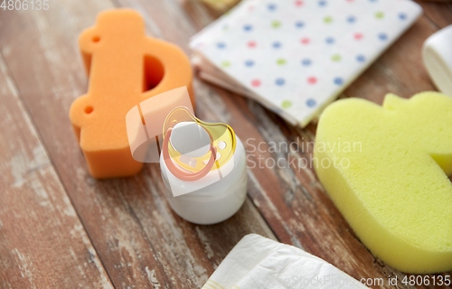 Image of baby accessories for bathing on wooden table