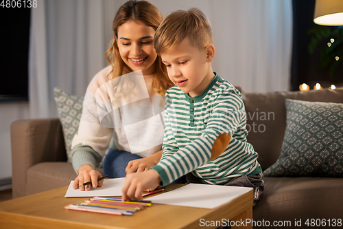 Image of mother and son with pencils drawing at home