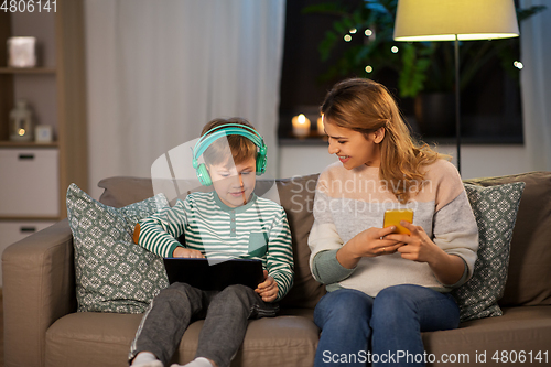 Image of mother and son using gadgets at home