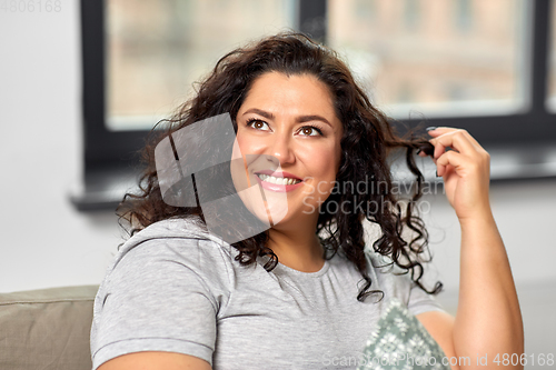 Image of portrait of happy young woman at home