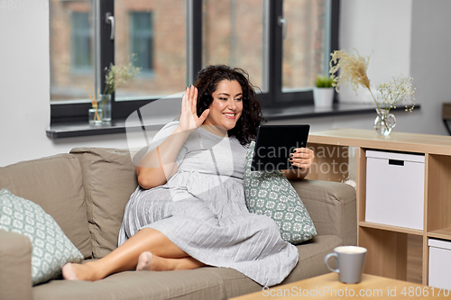 Image of woman with tablet pc having video chat at home