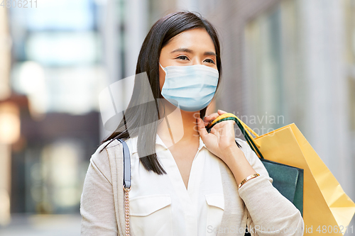 Image of asian woman in protective mask with shopping bags