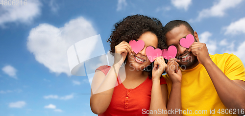 Image of happy african american couple with hearts