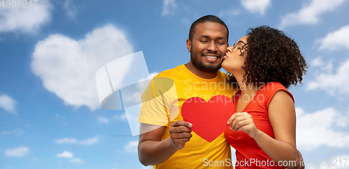 Image of happy african american couple wit red heart kiss