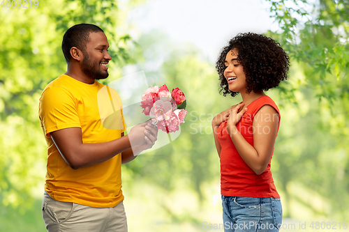 Image of happy african american couple with flowers