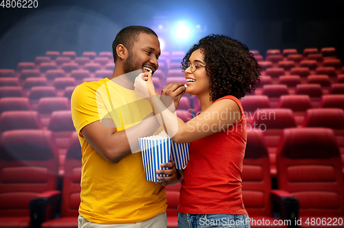 Image of happy african american couple eating popcorn