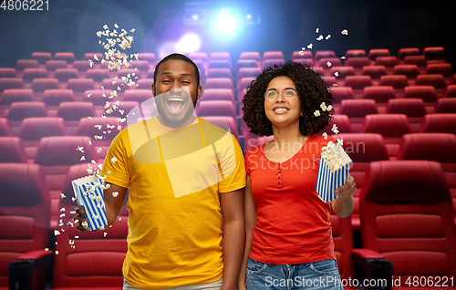 Image of happy friends watching movie in theater