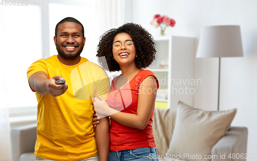 Image of african american couple with tv remote control