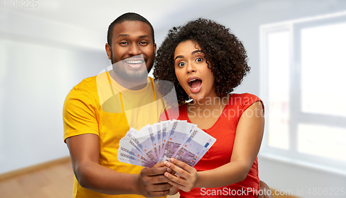 Image of african american couple with money at new home