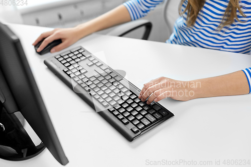 Image of close up of teenage girl with computer at home