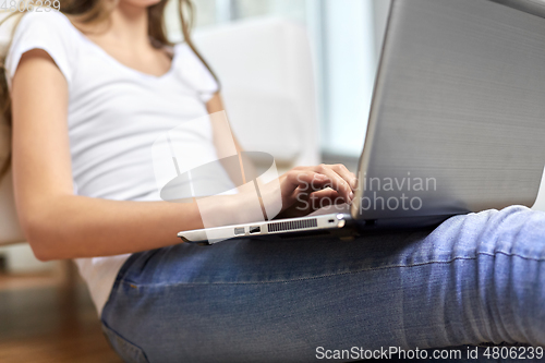 Image of teenage student girl with laptop and books at home