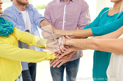 Image of group of students stacking hands