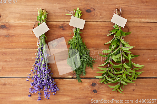 Image of lavender, dill and peppermint on wooden background