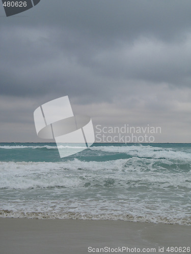 Image of turquoise tropical ocean and dark sky