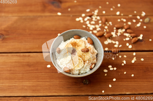 Image of oatmeal with banana and almond on wooden table