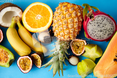 Image of different exotic fruits on blue background