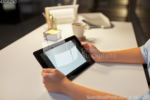 Image of businesswoman with tablet computer at night office